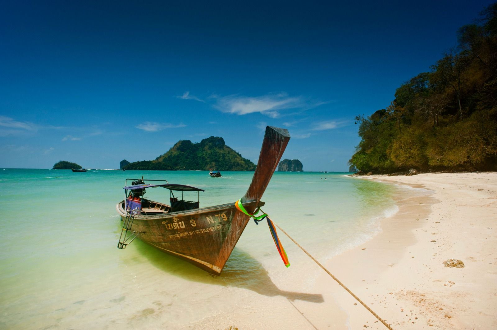 Longtail boat on a white sand beach in Thailand
