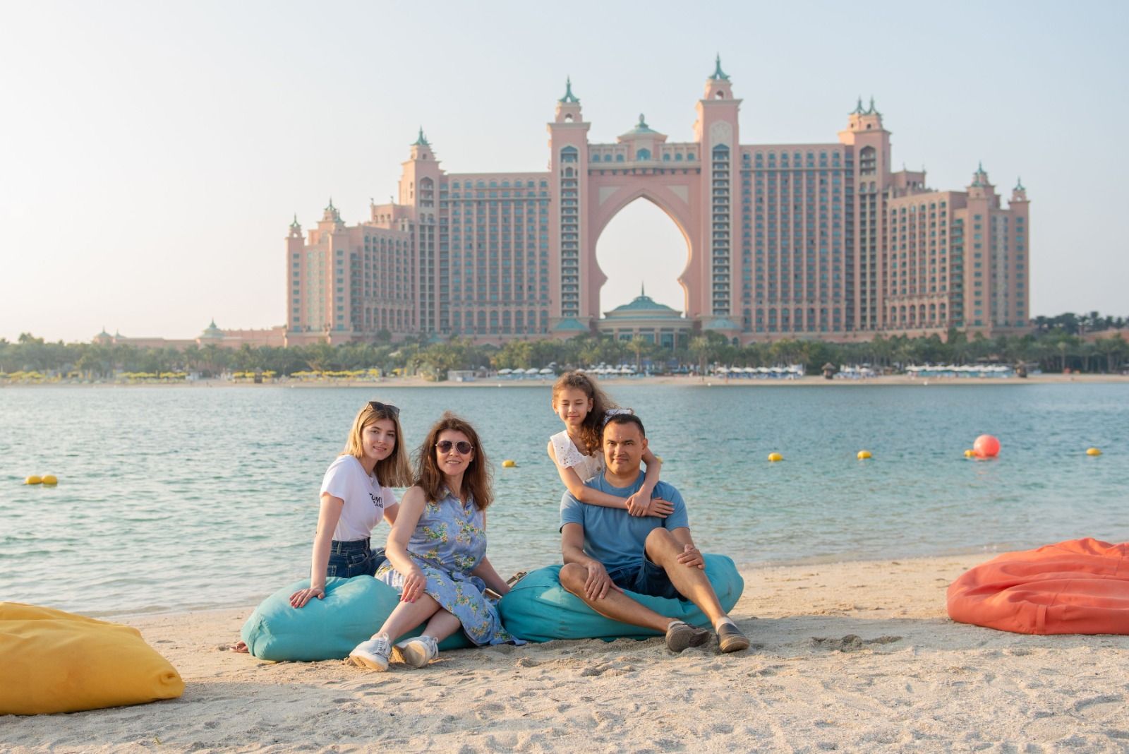 Family relaxing on a Dubai beach in front of a resort